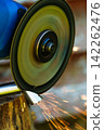 Cutting metal pipe with an angle grinder close-up 142262476