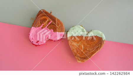 Creative isometric idea Valentine's Day Holiday celebration Heart shaped croissants on two colored background with copy space. Puff pastry new trendy sweet dessert bakery. Creamy dough Creative isometric idea Valentine's Day Holiday celebration Heart shaped croissants on two colored background with copy space. Puff pastry new trendy sweet dessert bakery. Creamy dough 142262984
