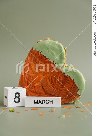 8 March Women's day Female holiday greeting card Heart shaped pistachio croissant on green background with copy space. Puff pastry new trendy sweet dessert bakery. Creamy dough 8 March Women's day Female holiday greeting card Heart shaped pistachio croissant on green background with copy space. Puff pastry new trendy sweet dessert bakery. Creamy dough 142263001