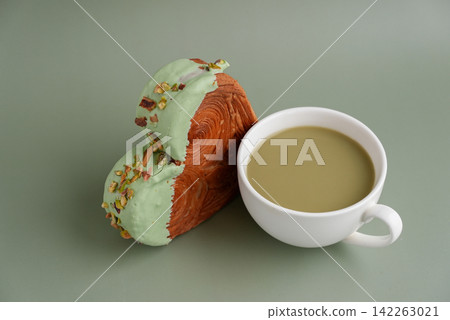 Nutrient-rich matcha drink with Green latte Matcha tea coffee with Delightful and vibrant heartshaped pastry croissant treat, beautifully topped with colorful frosting nut galore. Mock up template Nutrient-rich matcha drink with Green latte Matcha tea coffee with Delightful and vibrant heartshaped pastry croissant treat, beautifully topped with colorful frosting nut galore. Mock up template 142263021