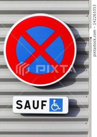 No stopping or parking road sign on a wall except for people with disabilities in France 142263353