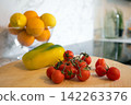 Fresh Tomatoes, Yellow Pepper and Citrus in Kitchen 142263376
