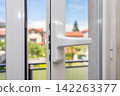 White Window Handle with Outdoor View 142263377
