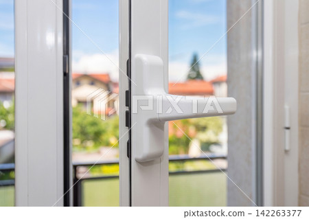White Window Handle with Outdoor View White Window Handle with Outdoor View 142263377