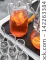 Orange Aperitif Cocktail in Glass Pitcher 142263384