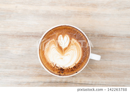 Closeup of cappuccino latte heart on dark old grunge with top view Closeup of cappuccino latte heart on dark old grunge with top view 142263788