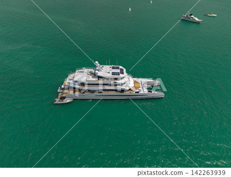 Luxury private yacht in sea. Motor yacht luxury vessel. Boat motor aerial. Vacation on summer season. Aerial view motorboat. Yacht boat tour. Luxury boat yachting. Motorboat sailing at sea Luxury private yacht in sea. Motor yacht luxury vessel. Boat motor aerial. Vacation on summer season. Aerial view motorboat. Yacht boat tour. Luxury boat yachting. Motorboat sailing at sea 142263939