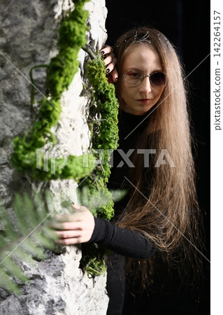 Botanical enthusiast observing textured rock and lively moss surface Botanical enthusiast observing textured rock and lively moss surface 142264157