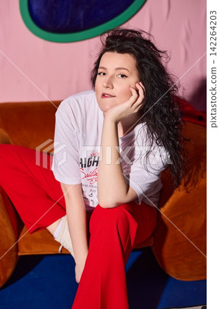 Smiling lady in colorful studio setting with cheerful attitude 142264203