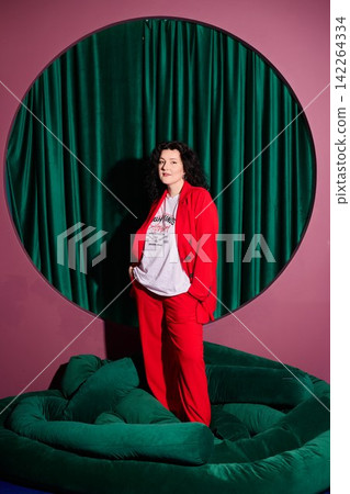 Woman dressed in red showcasing powerful leadership presence Woman dressed in red showcasing powerful leadership presence 142264334