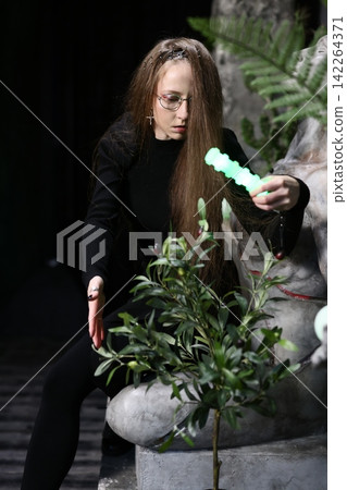 Peaceful setting with gardener shaping tiny glowing bonsai Peaceful setting with gardener shaping tiny glowing bonsai 142264371