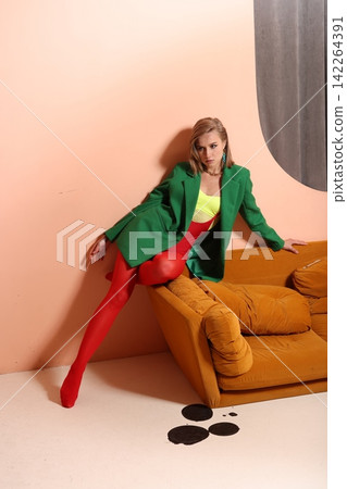 Woman experimenting with different body positions in colorful studio Woman experimenting with different body positions in colorful studio 142264391