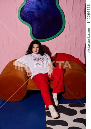 Tranquil setting featuring woman lounging comfortably in studio Tranquil setting featuring woman lounging comfortably in studio 142264518
