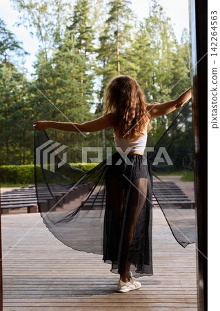 Performer spinning in nature with silky scarf and lively energy Performer spinning in nature with silky scarf and lively energy 142264563