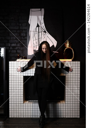 Darkly dressed performer illuminates scene with occult ambiance Darkly dressed performer illuminates scene with occult ambiance 142264614