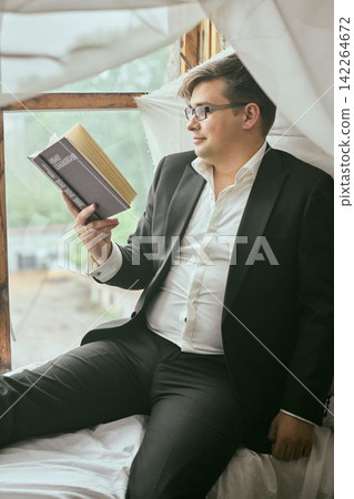 Male entrepreneur relaxes while planning in comfortable home setting Male entrepreneur relaxes while planning in comfortable home setting 142264672