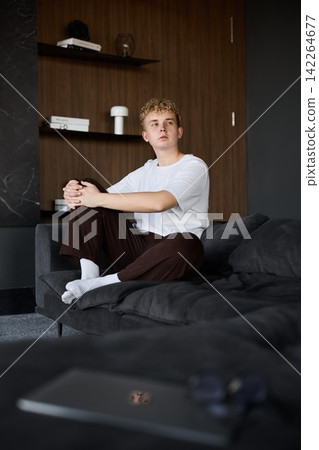 Young Caucasian male focused on inspiration through window view Young Caucasian male focused on inspiration through window view 142264677