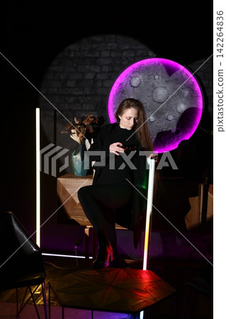 Serene individual under purple moon with neon light ambiance Serene individual under purple moon with neon light ambiance 142264836