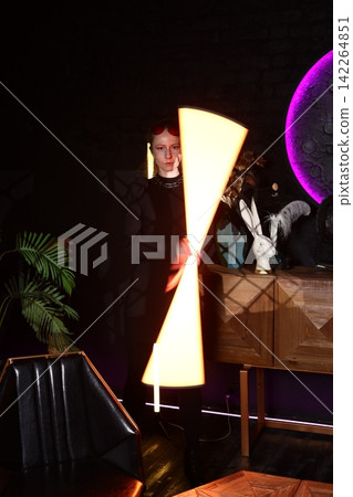 Dynamic scene of woman twirling neon lights energetically Dynamic scene of woman twirling neon lights energetically 142264851