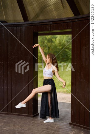 Trendy Caucasian performer mesmerizes viewers during park entrance display 142265189