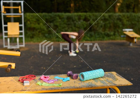Energized warmup outside with trainer emphasizing mobility exercises 142265272