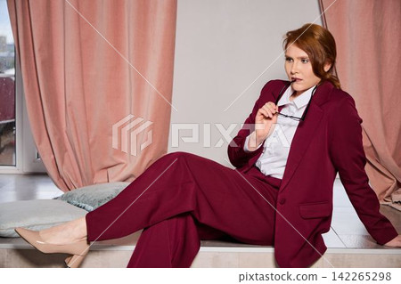 Thoughtful lady in distinctive blazer reviewing strategy documents Thoughtful lady in distinctive blazer reviewing strategy documents 142265298