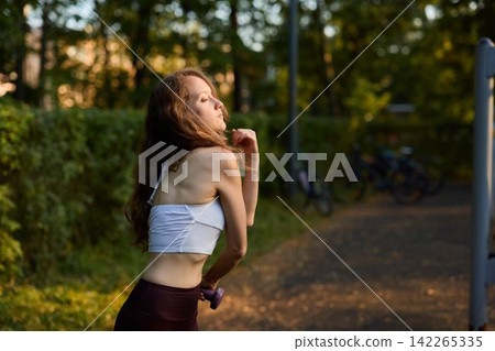 Caucasian runner cooling down with light weight and reflective pause Caucasian runner cooling down with light weight and reflective pause 142265335