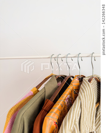 Summer Clothes on White Rack, Chrome Hook Detail Close-Up Summer Clothes on White Rack, Chrome Hook Detail Close-Up 142266348