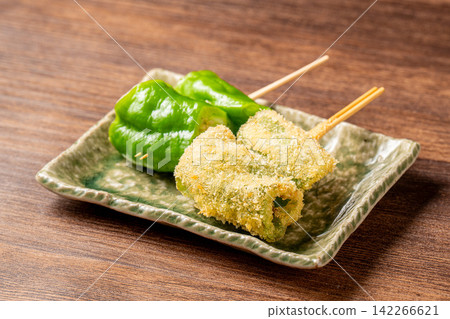 Delicious skewers of Manganji peppers with a slightly bitter taste. Delicious skewers of Manganji peppers with a slightly bitter taste. 142266621