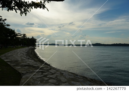 Serene Coastal View Calm Waters Lush Greenery Serene Coastal View Calm Waters Lush Greenery 142267770