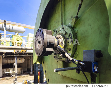 Close-up of laser shaft alignment tool installed on a large industrial rotating machine for precision measurement. Close-up of laser shaft alignment tool installed on a large industrial rotating machine for precision measurement. 142268045