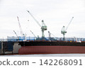 A large ship that is currently undergoing repairs. 142268091