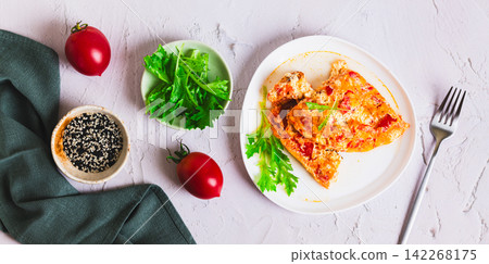 Tomato cheese omelette with herbs on a plate on the table top view web banner 142268175