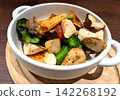 Mixed roasted vegetables, decorated in white ceramic bowl 142268192