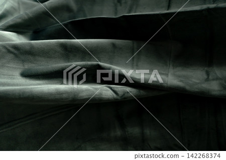 Dark grey velvet fabric with deep folds and rich texture Dark grey velvet fabric with deep folds and rich texture 142268374