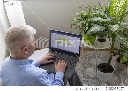 Senior Businessman Reviewing Mortgage Amortization Table on Laptop While Relaxing at Home Senior Businessman Reviewing Mortgage Amortization Table on Laptop While Relaxing at Home 142268471