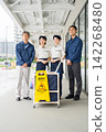 Four men and women who are staff members for building cleaning and facility maintenance. 142268480