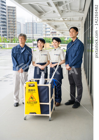 Four men and women who are staff members for building cleaning and facility maintenance. Four men and women who are staff members for building cleaning and facility maintenance. 142268482