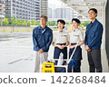 Four men and women who are staff members for building cleaning and facility maintenance. 142268484
