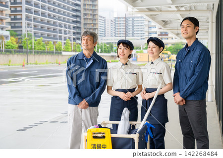 Four men and women who are staff members for building cleaning and facility maintenance. Four men and women who are staff members for building cleaning and facility maintenance. 142268484