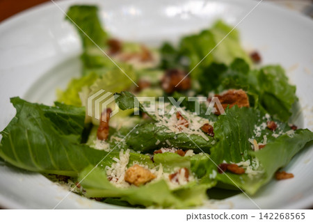 Salad served in a bowl, on the table 142268565