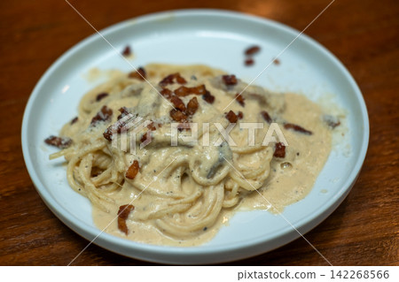 Spaghetti Carbonara with bacon served on a white plate. Soft Focus. Spaghetti Carbonara with bacon served on a white plate. Soft Focus. 142268566