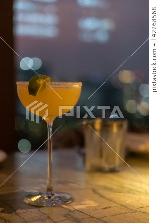 Close up view of orange cocktail on the table with bokeh background Close up view of orange cocktail on the table with bokeh background 142268568