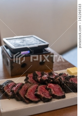 Set of Black Gyukatsu or beef cutlet served with butter. A traditional Japanese food that consists of a deep-fried beef cutlet. Set of Black Gyukatsu or beef cutlet served with butter. A traditional Japanese food that consists of a deep-fried beef cutlet. 142268583