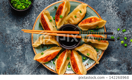 Dumplings served on a plate with green onions Dumplings served on a plate with green onions 142268968