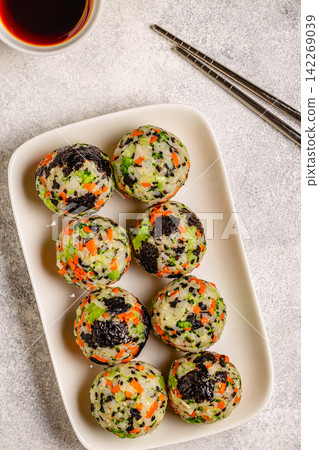 Korean rice balls (jumeokbap) with vegetables served with sauce Korean rice balls (jumeokbap) with vegetables served with sauce 142269039