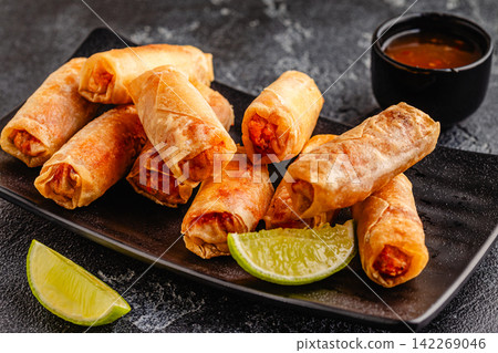 Fried spring rolls served with sauce and lime Fried spring rolls served with sauce and lime 142269046