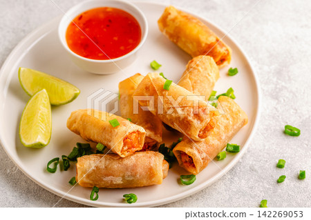 Fried spring rolls served with lime and sauce Fried spring rolls served with lime and sauce 142269053