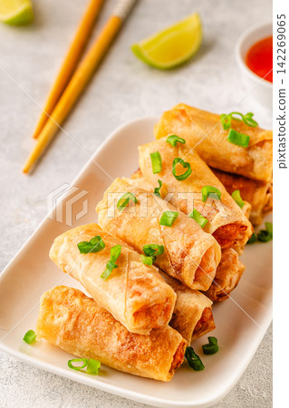 Fried spring rolls served with lime and sauce Fried spring rolls served with lime and sauce 142269065