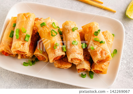 Fried spring rolls served with lime and sauce Fried spring rolls served with lime and sauce 142269067